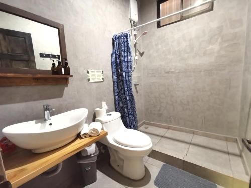 a bathroom with a sink and a toilet and a shower at Riverside Apartments - Walk to the Beach in Santa Teresa! Newly Renovated! in Santa Teresa Beach