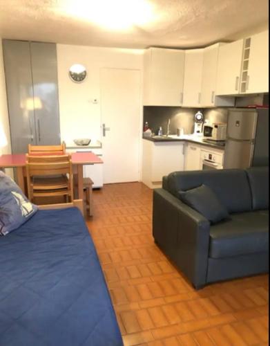 un salon avec un canapé et une cuisine dans l'établissement Cap D 'Agde Studio cabine 5 personnes, vue chenal, au Cap d'Agde