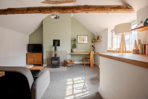 a living room with a couch and a fireplace at Charming flat in lovely rural location in Laneham
