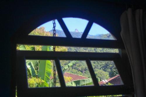 a view from a window looking out at the forest at Pousada Tropicana in Abraão