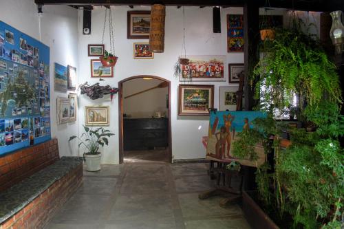 a room with plants and pictures on the wall at Pousada Tropicana in Abraão