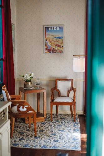 a living room with a chair and a table at Boutique Hotel Dobra Vila Bovec in Bovec
