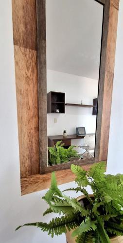 a mirror in a room with a living room at EM Somos AT HOME Lindo Apartamento con Aire Acondicionado in Neiva