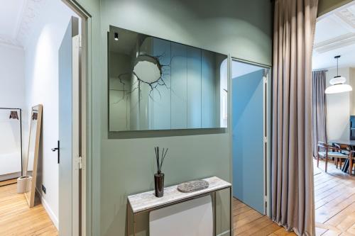 Cette chambre comprend une table et un miroir mural. dans l'établissement Luxury appartment near Louvre -TopQuartier- near metro, à Paris