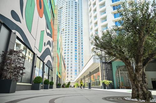a street in a city with tall buildings at Portokali Sky Apartment in Skopje