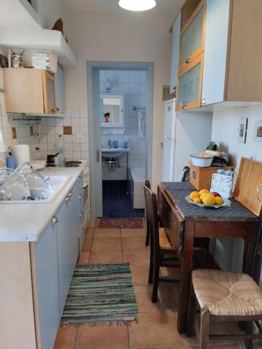 a kitchen with a table with fruit on it at Traditional house at Vasilika, Lesvos in Vasiliká