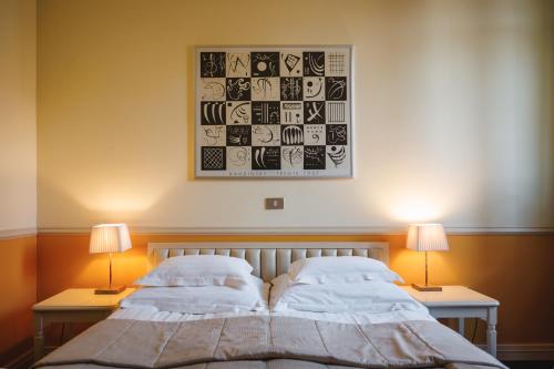 a bedroom with two beds and two lamps and a picture at Boutique Hotel Dobra Vila Bovec in Bovec