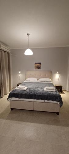 a bedroom with a large bed in a room at Tsanis in Parga