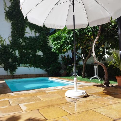 an umbrella sitting next to a swimming pool at Suite Comares in Granada