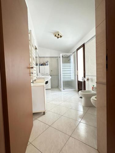 a bathroom with a toilet and a sink at Maria s Apartment in Tertenìa