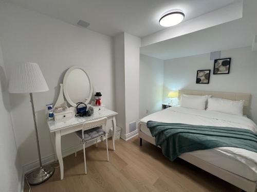 um quarto com uma cama e um toucador com um espelho em Cozy, brand-new, 2BDR,walkout apt, free parking em Richmond Hill
