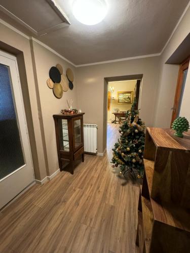 a living room with a christmas tree in a room at Antico Borgo - Appartamento in Cavriglia
