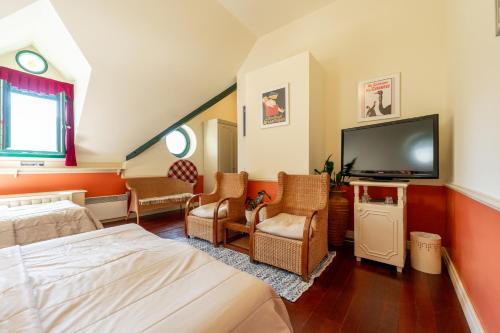 a hotel room with a bed and a flat screen tv at Boutique Hotel Dobra Vila Bovec in Bovec