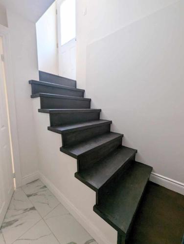 a stairway with green steps in a room at Wonderland apartment - 6 min by walking in Vaughan