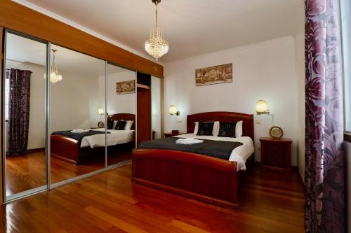 a bedroom with two beds and a mirror at Villa Passion by AnaLodges in Funchal