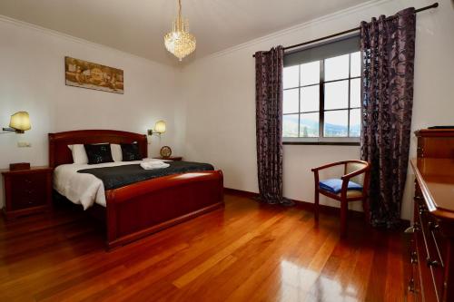 a bedroom with a bed and a large window at Villa Passion by AnaLodges in Funchal
