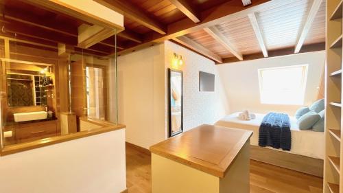 a room with a bathroom with a bed and a window at The Cliffs - MarCastelos in Viveiro