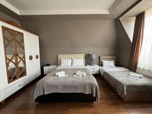 um quarto com 2 camas e toalhas em Hotel Rich em Tbilisi