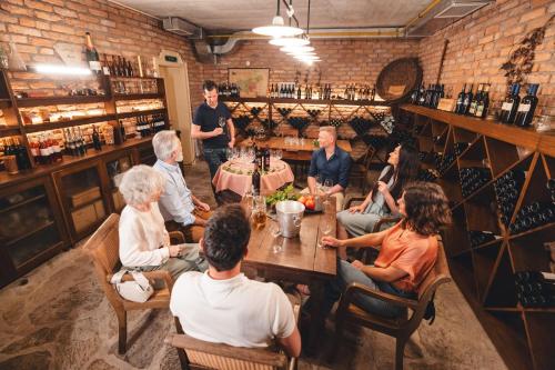 a group of people sitting around a table in a restaurant at Boutique Hotel Dobra Vila Bovec in Bovec