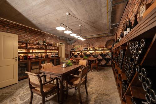 a dining room with a table and some wine racks at Boutique Hotel Dobra Vila Bovec in Bovec