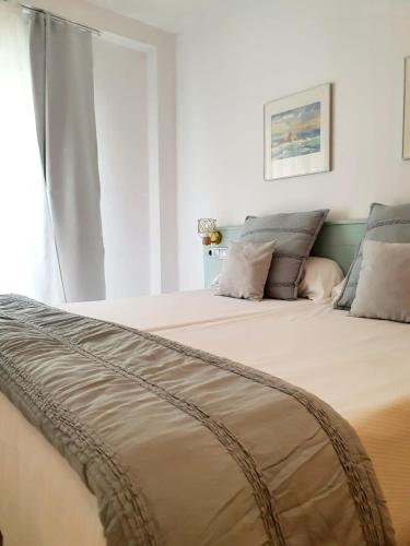 a bedroom with a large bed with a window at Fleming Center by Punta 25 Hotels Group in Benidorm
