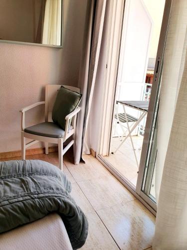 a living room with a chair and a window at Fleming Center by Punta 25 Hotels Group in Benidorm