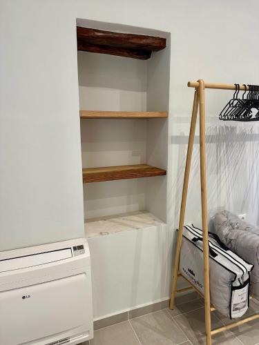 a room with a closet with wooden shelves at Alexander House 2 in Leonidion
