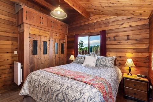 - une chambre avec un lit dans une cabane en rondins dans l'établissement Juniper Lane Guest House, à Friday Harbor