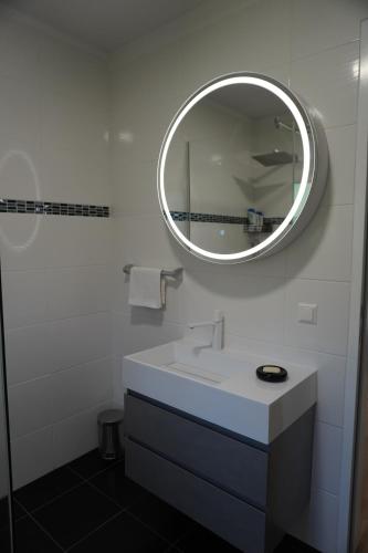 a white bathroom with a sink and a mirror at Casa Capodistria with sea view in Koper