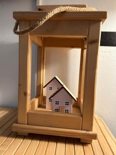 a small house in a wooden frame on a table at the green nest in Olginate