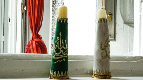 two candles are sitting on a window sill at Exquisite Riad Beach & Surf in Rabat