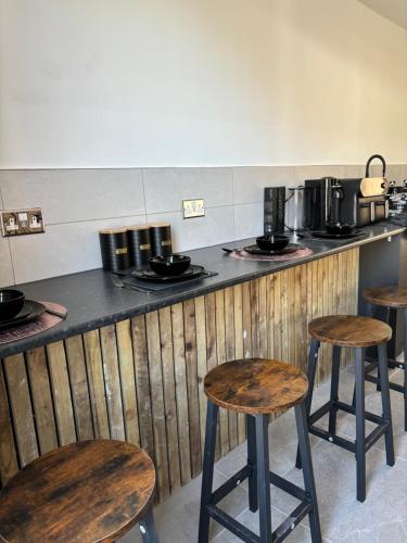 リバプールにあるWilliamson Suites - Apartment 1のカウンター前のキッチン(木製のスツール付)