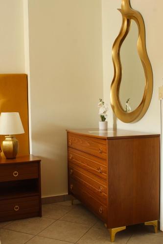 a dresser with a mirror on top of it at Sofotel in Koroni
