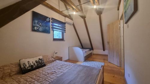 een slaapkamer met een bed en een raam in een kamer bij Green Garden Lohovo in Bihać