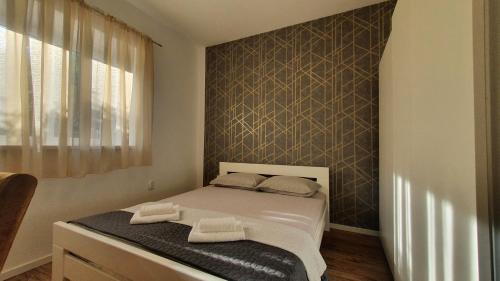 Ένα ή περισσότερα κρεβάτια σε δωμάτιο στο Apartmani DaNiMa