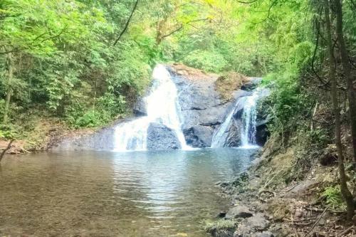 a waterfall in the middle of a pool of water at La Parada del Pelicano, El Ranchito Surf in Malena