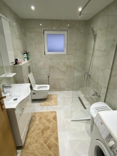 a bathroom with a shower and a toilet and a sink at "Golden Dream" in Jajce