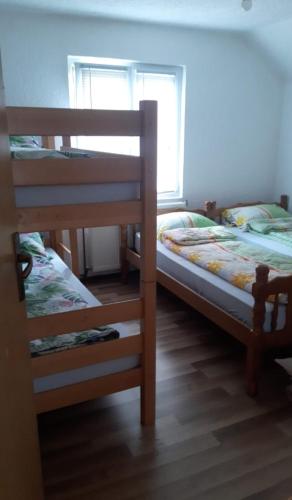 two bunk beds in a room with a window at "Golden Dream" in Jajce