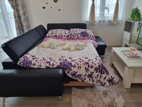 a black couch with a purple blanket on it at Bruno 1 in Senj