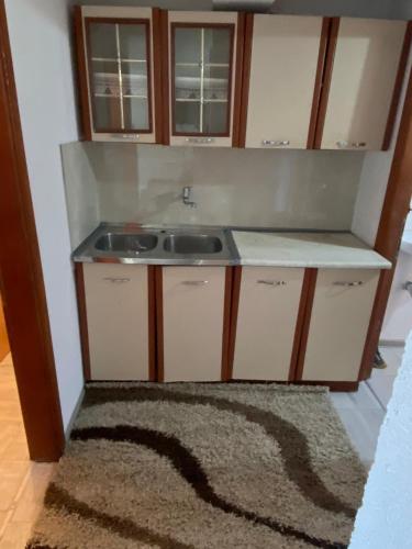 a small kitchen with a sink and a rug at "Golden Dream" in Jajce