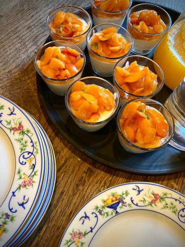 a tray filled with bowls of orange fruit on a table at Château de La Tour en Brenne in Rivarennes