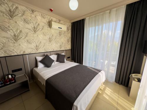 Postel nebo postele na pokoji v ubytování Sardunya Hotel