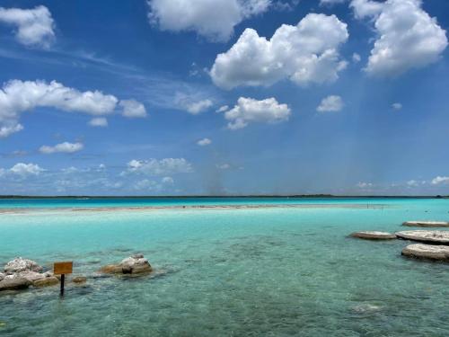 a view of the ocean with rocks in the water at Blue Caribe Bacalar Front Lagoon in Bacalar