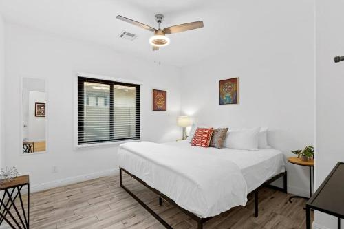 a white bedroom with a bed and a window at Hummingbird Harmony House with BBQ and Hot Tub in Downtown Phoenix in Phoenix