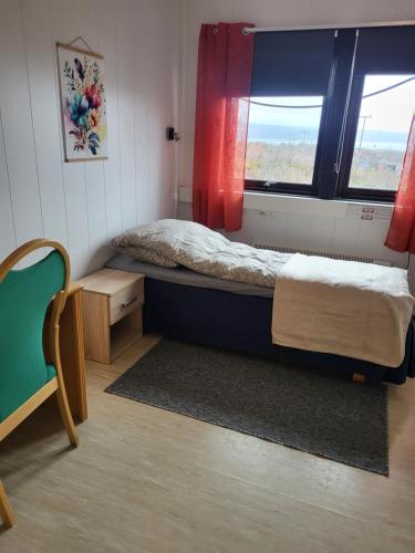 a small bedroom with a bed and a window at Odd inge Sør-Reime as in Nesseby