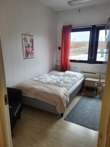 a small bedroom with a bed and a window at Odd inge Sør-Reime as in Nesseby