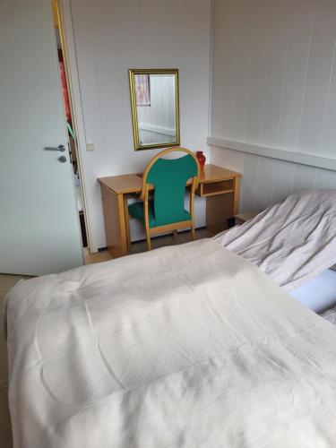 a bedroom with a bed and a desk and a chair at Odd inge Sør-Reime as in Nesseby