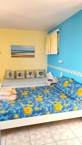 a bedroom with a large bed with flowers on it at Aeolos Studios Kefalonia in Khelmáta
