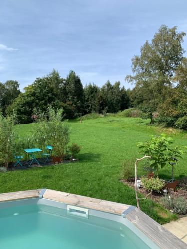a swimming pool in a yard with a field at Chez Isa in Faymonville