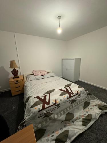 a bedroom with a large bed with a long nightstand at Transformative housing lismore close in Nottingham